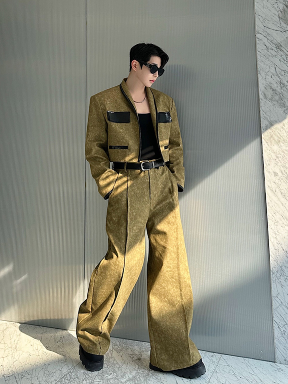 Man in a cropped olive-green jacket