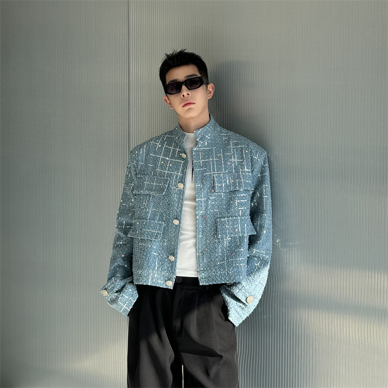 Man in a textured light blue jacket with a grid pattern