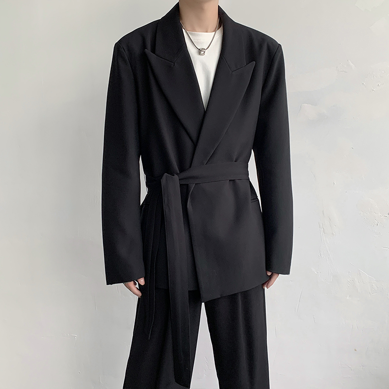 Man in an oversized black suit