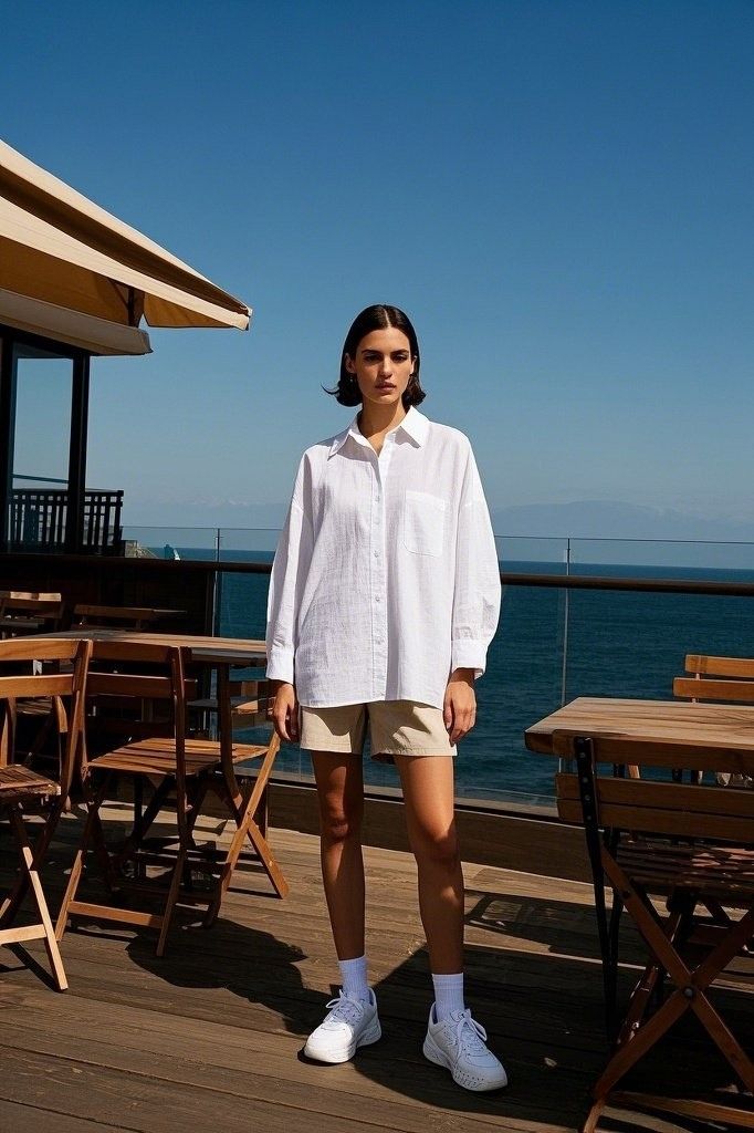 Casual Seaside Vibes: A White Oversized Button-Down Shirt - with Beige Shorts - White Socks - and Sneakers