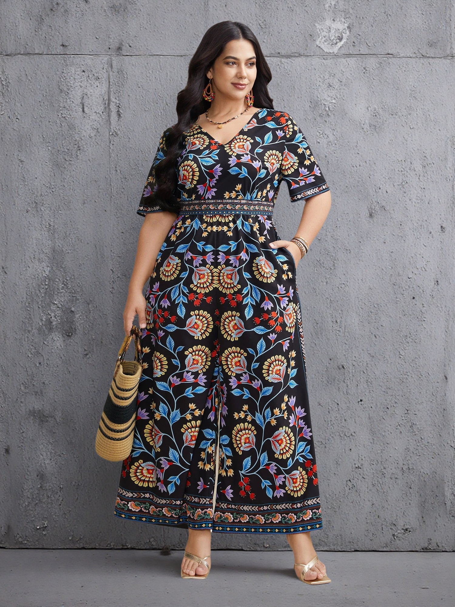 A plus-size woman wearing a vibrant floral-patterned jumpsuit in spring