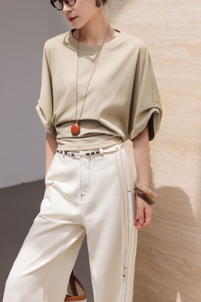 Black glasses + sandstone oversized tee + ivory wide-leg jeans