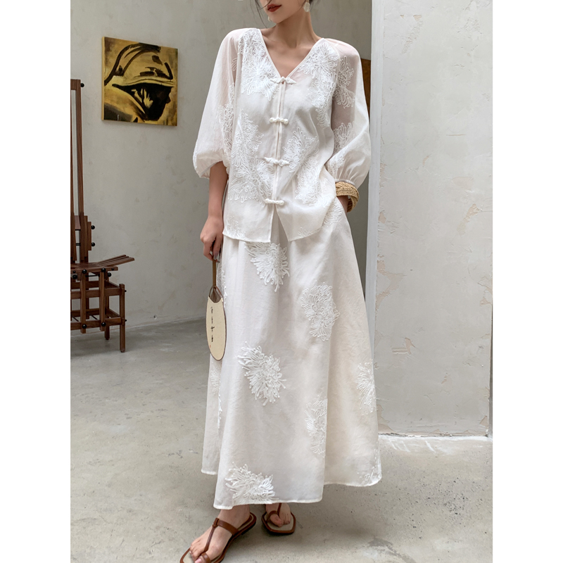 Low bun + ivory frog-button blouse + embroidered midi skirt + tan leather sandals