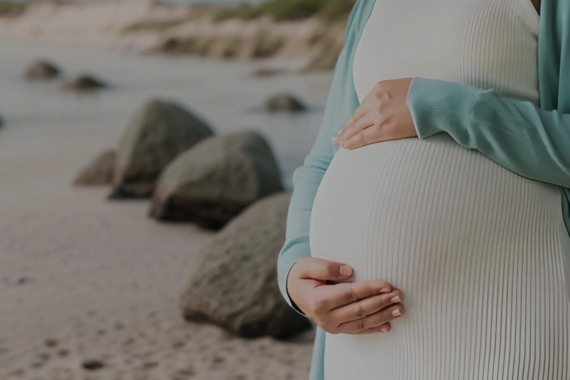 Houston Surrogacy – Surrogate Mother Gently Touching Her Pregnant Belly
